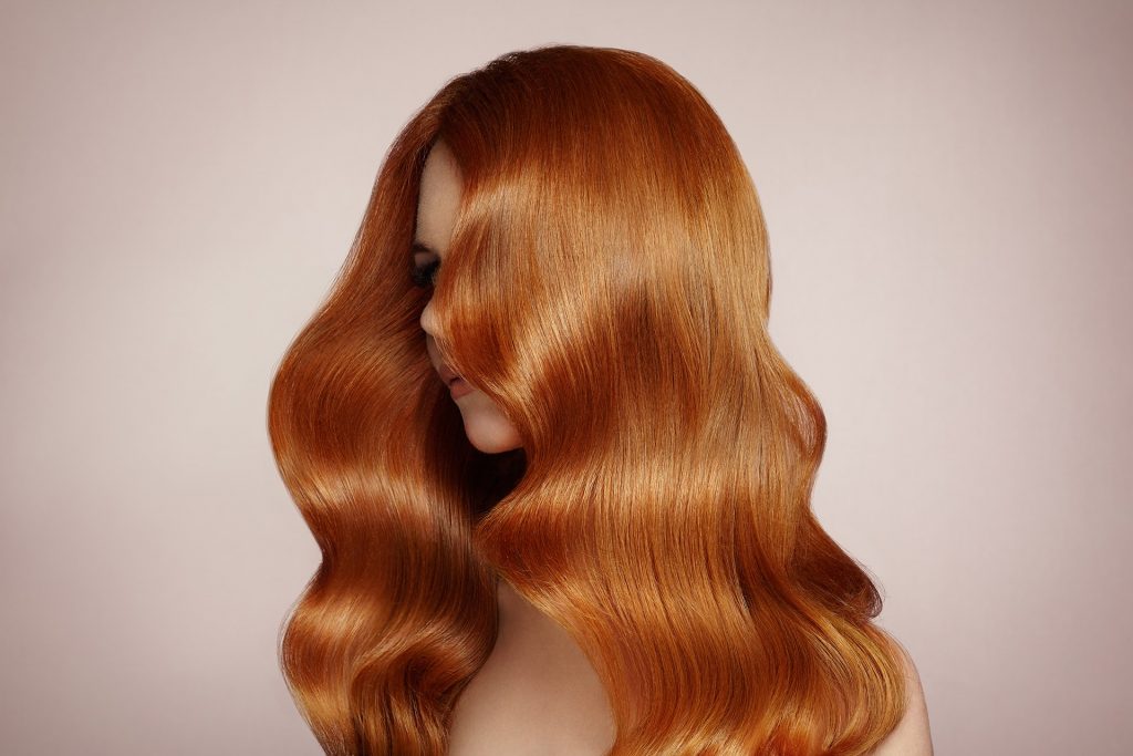 redhead woman with curly hair EAVCZL min