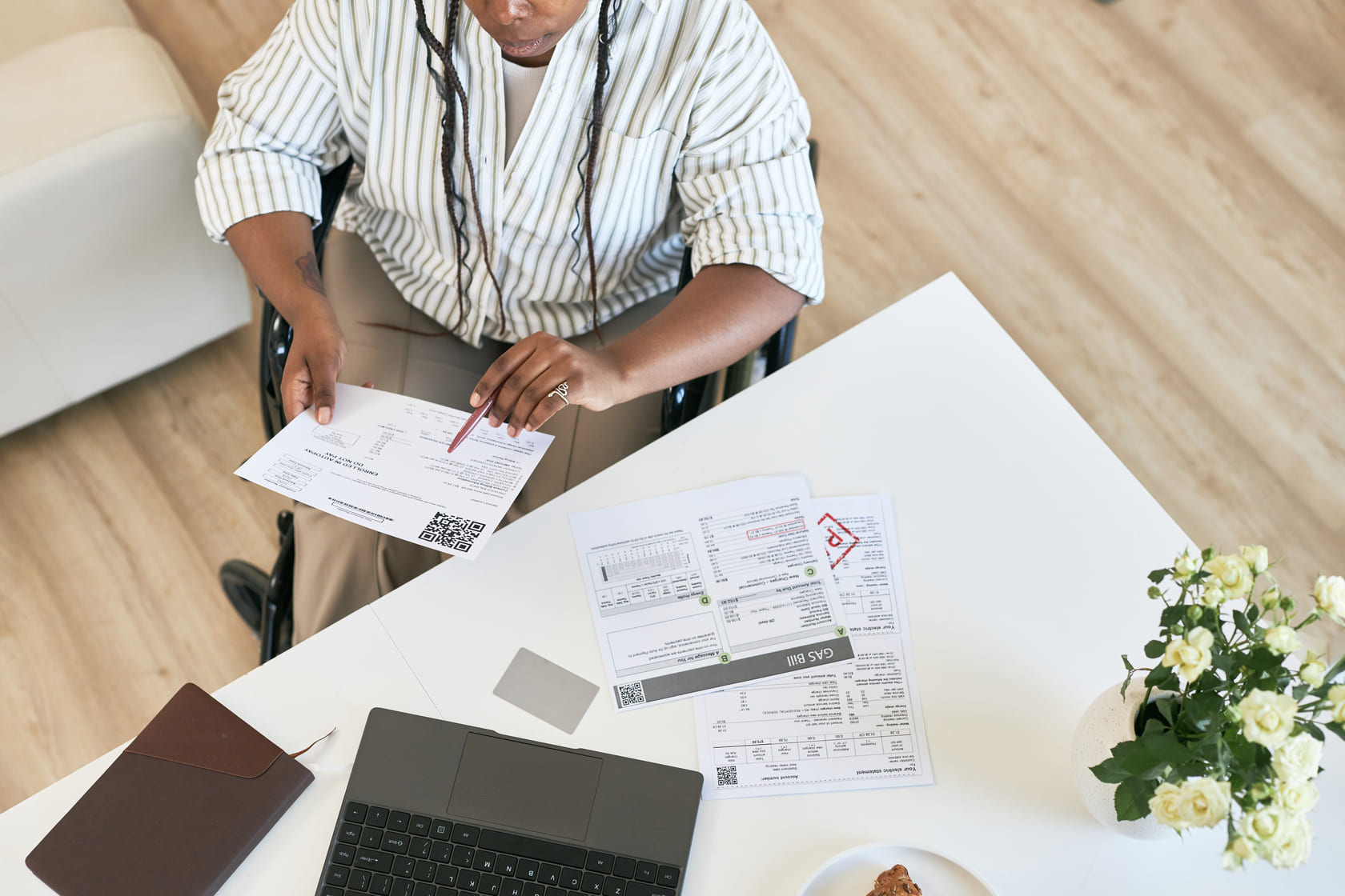 reviewing-documents-while-sitting-in-wheelchair-at-2025-03-08-16-29-47-utc-0183700