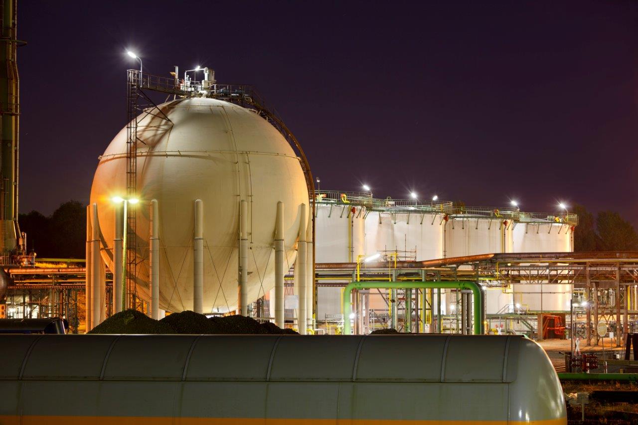 oil-and-gas-storage-tanks-at-night-E93WAMB haraka energy solutions
